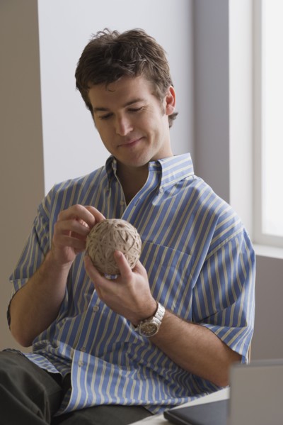 Portrait of businessman with ball of wool. Photo: Rob Lewine