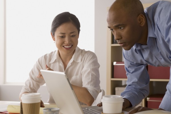 Two business people working in office. Photo : Rob Lewine