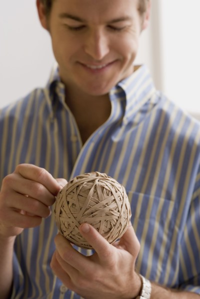 Young man holding ball made of paper. Photo : Rob Lewine