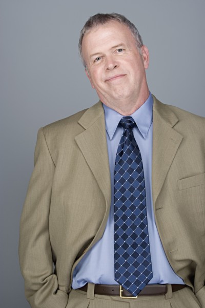 Portrait of happy mature businessman. Photo : Rob Lewine