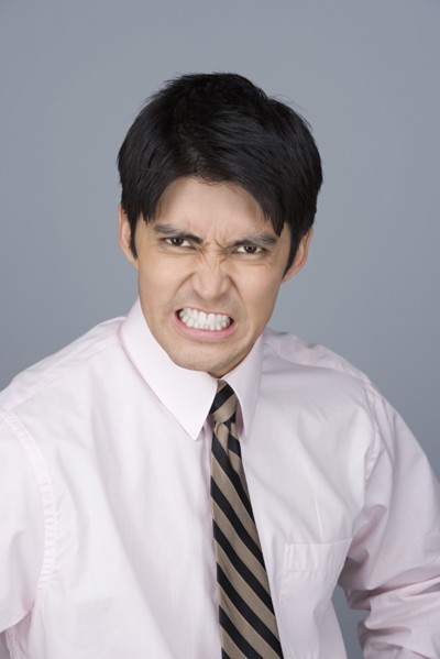 Portrait of young businessman pulling funny faces. Photo: Rob Lewine