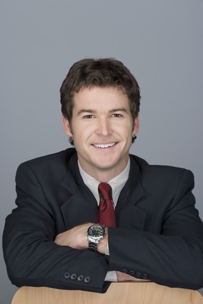 Portrait of happy young businessman. Photo : Rob Lewine