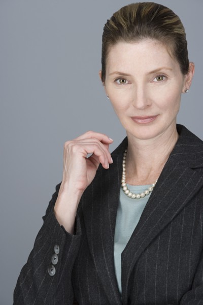 Portrait of cheerful mature businesswoman. Photo : Rob Lewine