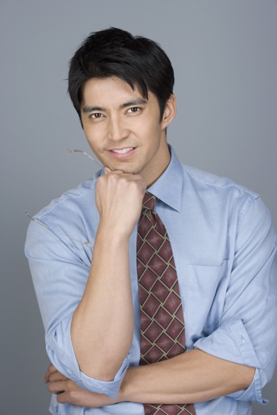 Portrait of happy young businessman. Photo: Rob Lewine