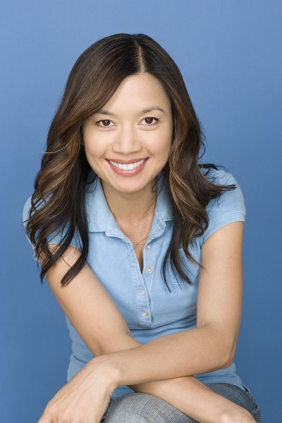 Portrait of happy asian woman wearing blue polo shirt. Photo : Rob Lewine