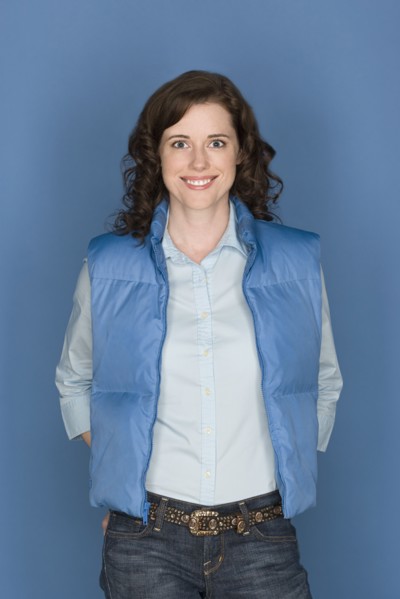 Portrait of happy mid adult woman wearing blue vest. Photo: Rob Lewine