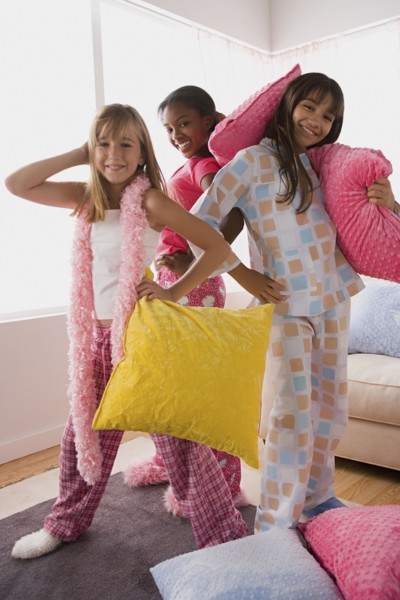 Portrait of three girls (10-11) playing at slumber party. Photo : Rob Lewine