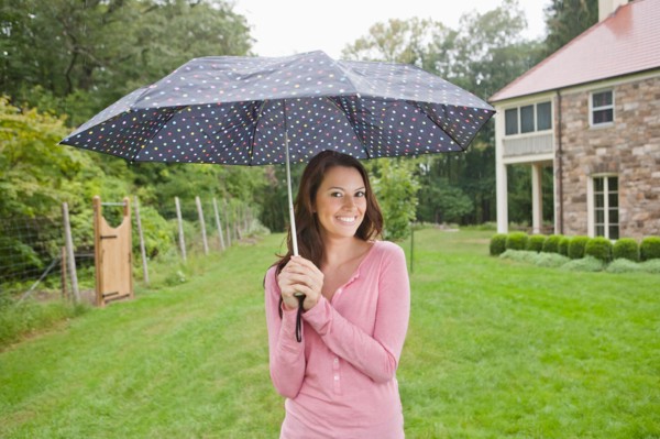 USA, New Jersey, Portrait of woman holding umbrella. Photo : Tetra Images