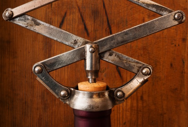 Studio shot of corkscrew opening bottle.