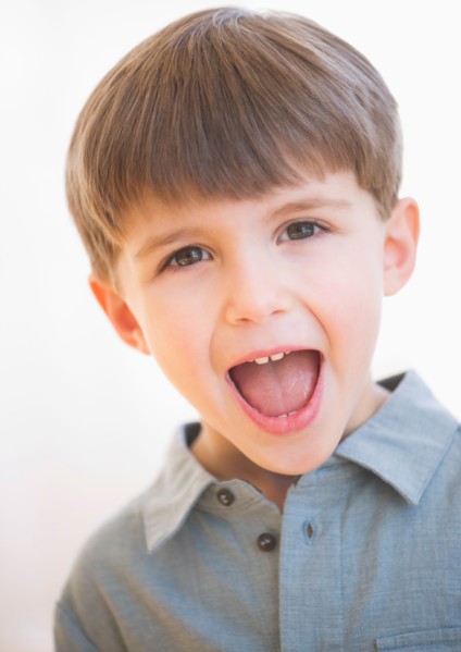 Studio portrait of boy (4-5) yelling.