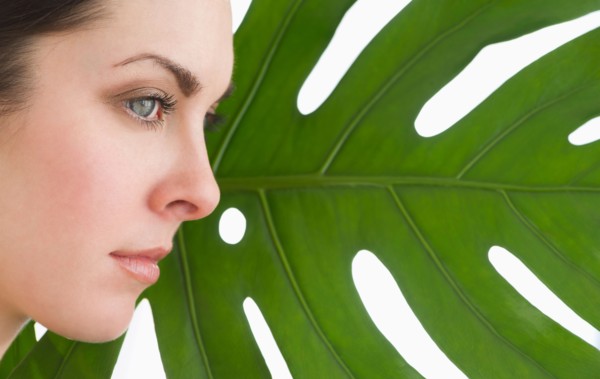 Studio shot of woman and leaf.