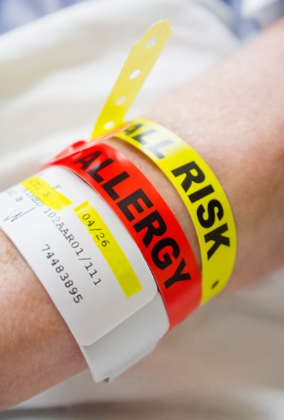 Close up of patient's hand with information wrist bands.