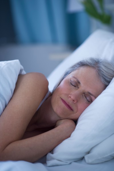 Senior woman sleeping in bed .