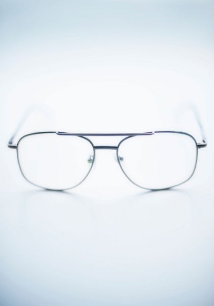 Close up of glasses on blue background, studio shot.