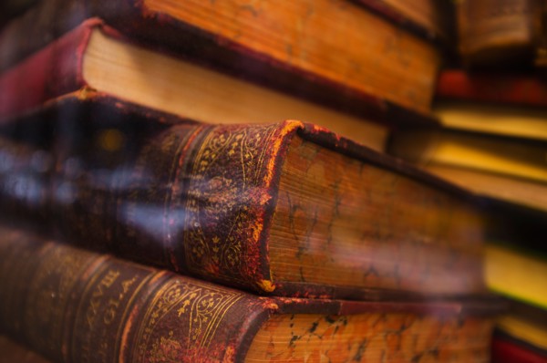 Close up of antique books in leather covers, studio shot.