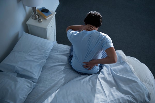 Man sitting on bed .