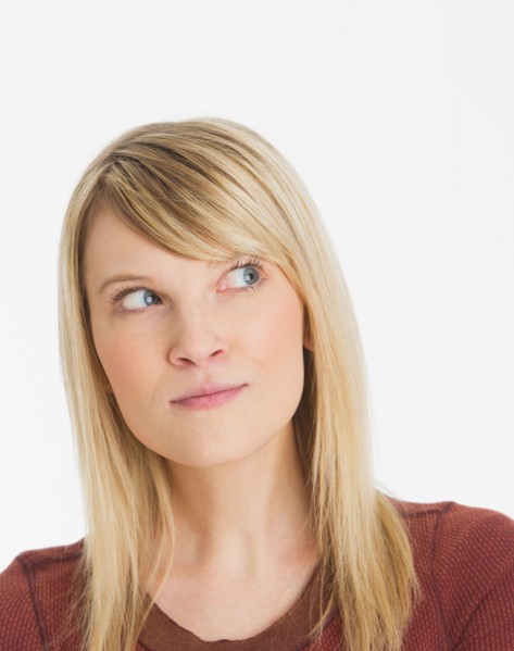 Studio portrait of pensive woman.