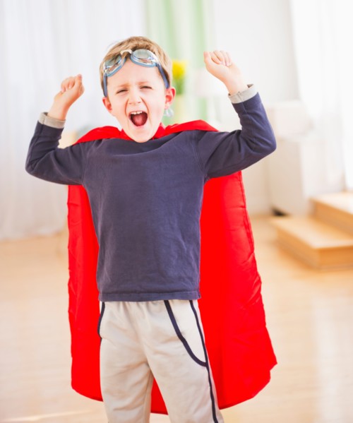Portrait of boy (6-7) wearing superhero costume. Photo : Daniel Grill