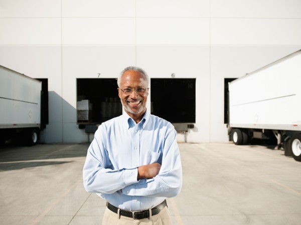 Portrait of businessman outside warehouse.