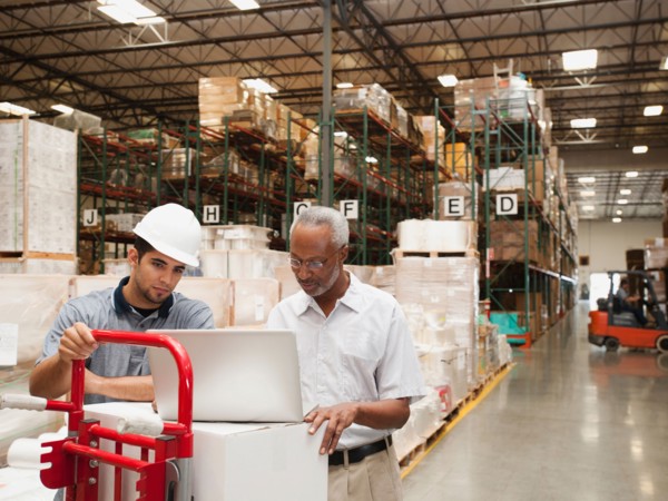 Men working in warehouse.