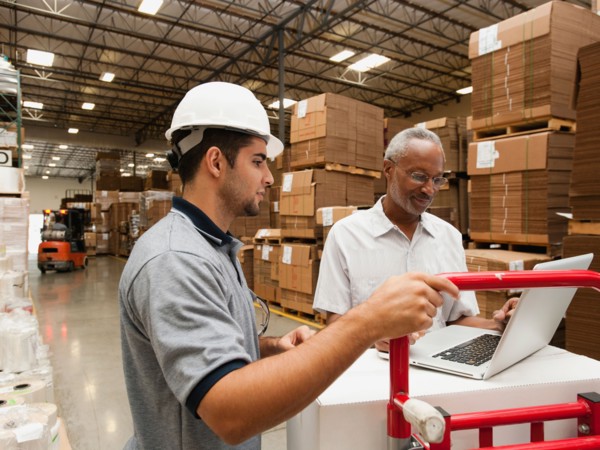 Men working in warehouse.