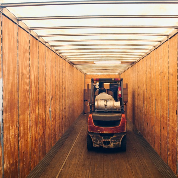 Forklift truck inside trailer.