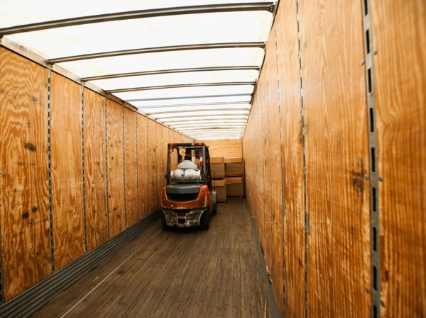 Forklift truck inside trailer.