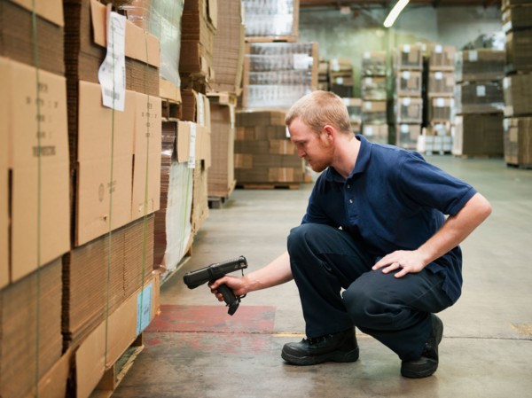 Warehouse worker scanning delivery.