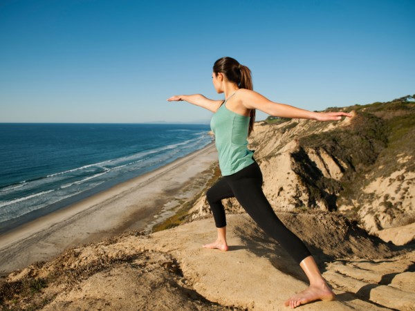 USA, California, San Diego, Woman practicing yoga on beach.
