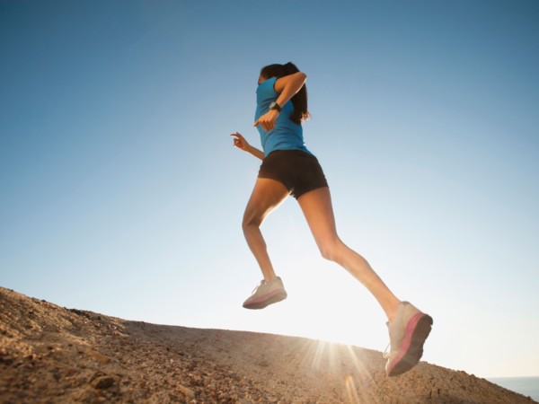 USA, California, San Diego, Woman jogging along sea coast.
