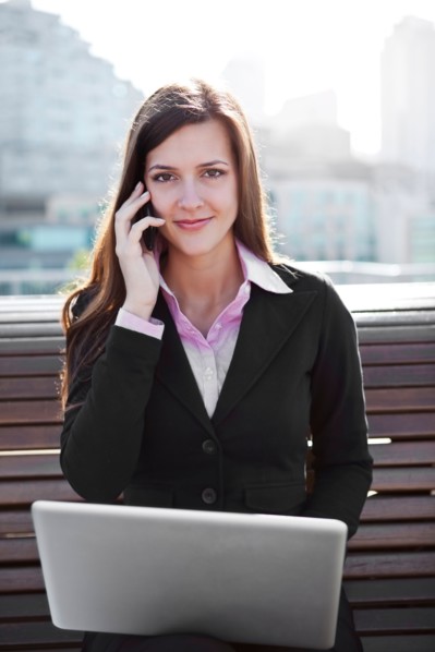 USA, Seattle, Young businesswoman sitting on bench and working. Photo : Take A Pix Media