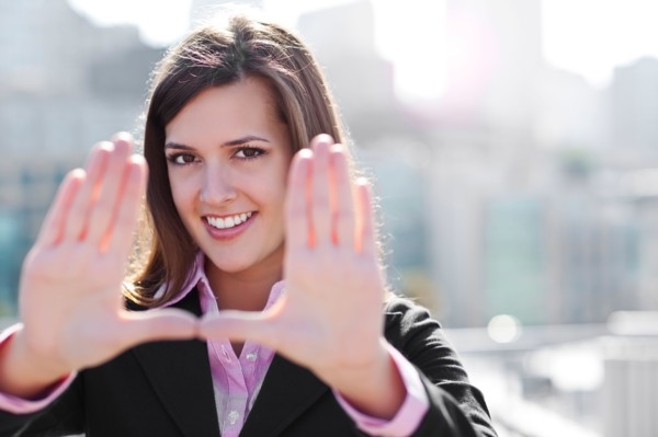 USA, Seattle, Smiling businesswoman making frame with hands. Photo : Take A Pix Media
