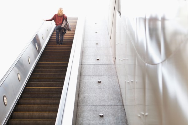 USA, California, Los Angeles, Woman on escalator in subway station. Photo : Sarah M. Golonka