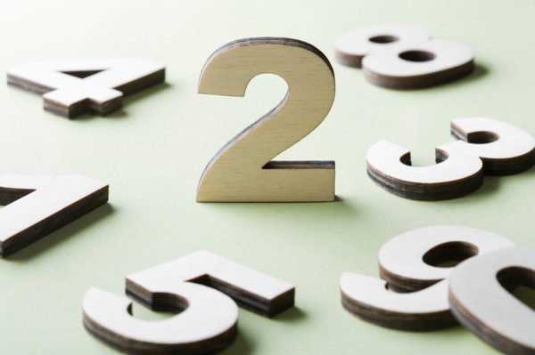 Numbers on white background, studio shot. Photo : Kristin Lee