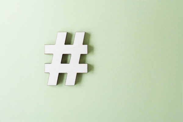 Hashtag on white background, studio shot. Photo : Kristin Lee