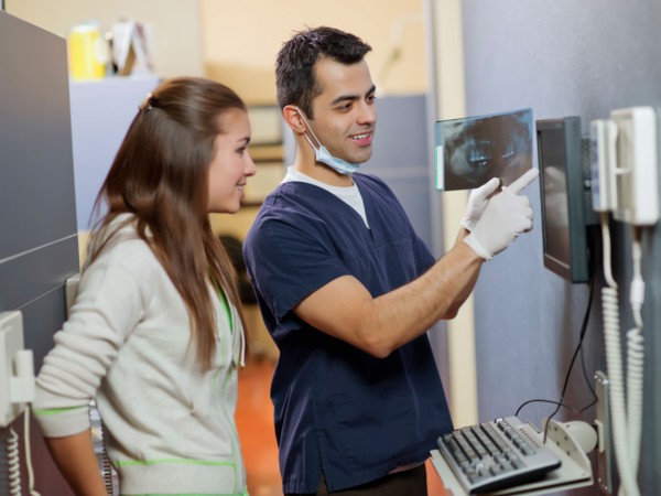 Dentist and patient looking at x-ray . Photo : Dan Bannister