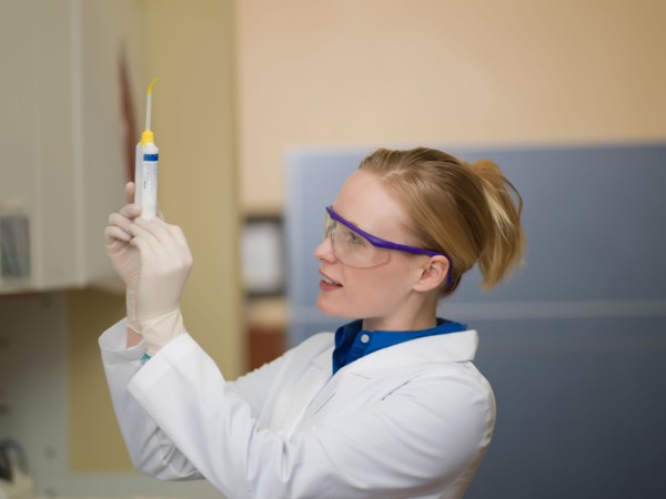 Portrait of dentist holding dental tools. Photo : Dan Bannister