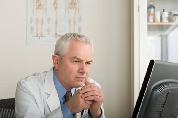 Doctor working on computer. Photo : Rob Lewine