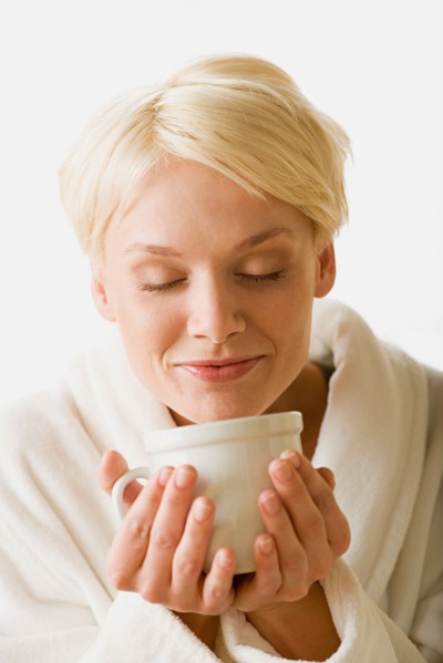 Woman enjoying hot drink. Photo : Rob Lewine