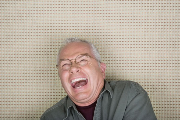 Studio portrait of senior man laughing. Photo : Rob Lewine
