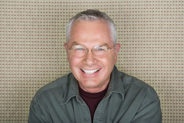 Studio portrait of senior man smiling. Photo : Rob Lewine