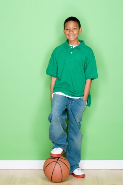 Studio portrait of teenage boy with basketball. Photo : Rob Lewine