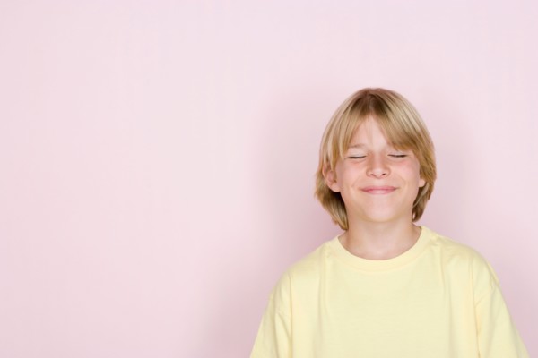 Studio shot portrait of teenage boy with eyes closed, head and shoulders. Photo : Rob Lewine