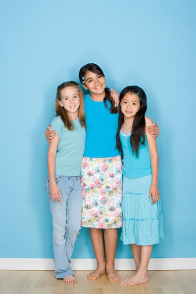 Studio shot portrait of three teenage girls, full length. Photo : Rob Lewine