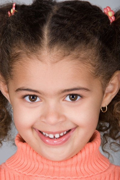 Studio portrait of happy pre-teen girl (10-11). Photo : Rob Lewine