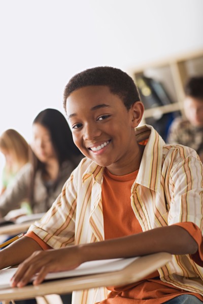 Schoolboy sitting in classroom. Photo : Rob Lewine
