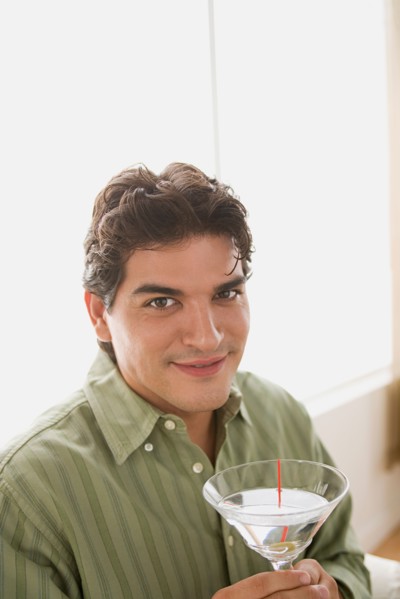 Portrait of smiling man having cocktail. Photo : Rob Lewine