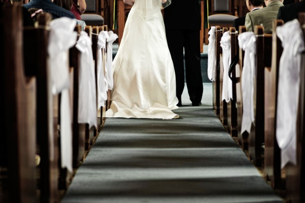 Low section of bride and groom in church. Photo :  Elena Elisseeva