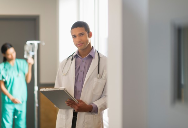 Portrait of male doctor in hallway.