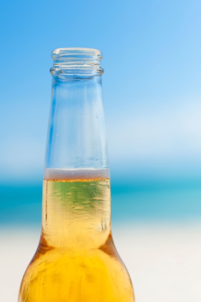 Beer bottle on beach.